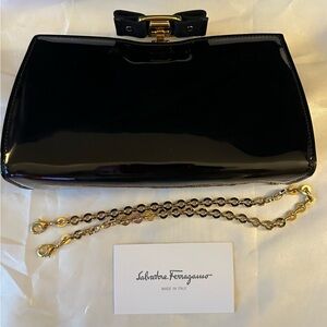 Salvatore Ferragamo black patent Vera Clutch Bag.